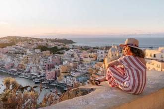 woman admiring sunset above the cityscape