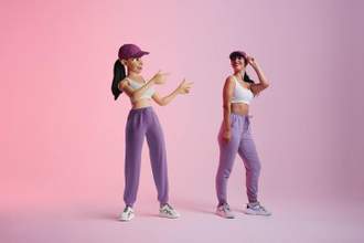 woman and her avatar interacting with each other in front of pink background