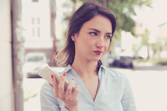 woman annoyed by something on her phone