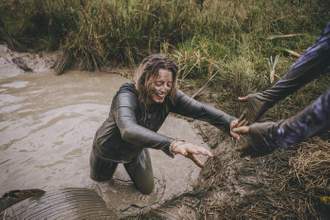 woman being pulled out of the mud
