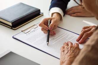 woman discussing contract with lawyer