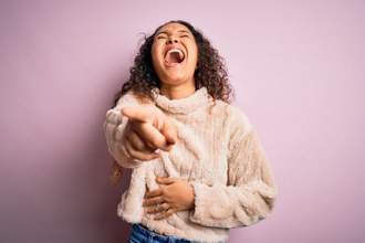 woman laughing hard while pointing