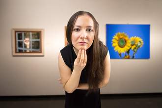 woman leaning toward art in museum