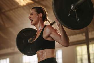 woman lifting weights in the gym