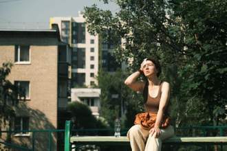 woman looking miserable sweating outdoors during a summer heatwave