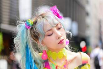 woman looking off to the right wearing an eccentric outfit