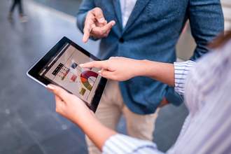 woman pointing to statistics on tablet