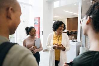 woman talking to students
