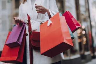 woman walking around with a large number of shopping bags