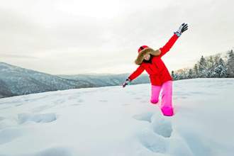 woman walking through the deep snow