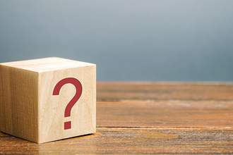 wooden block with question mark on it