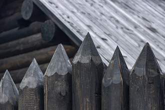 wooden fence topped with spikes