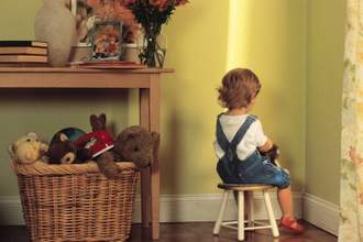 young child sitting in the corner
