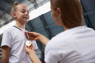 young female athlete being awarded a medal