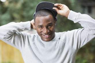 young man pulling off his hat