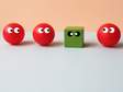 image of a green cube out of place in a lineup of red spheres