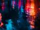 neon lights reflected in puddles after rain