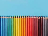 a row of colored pencils on a blue background